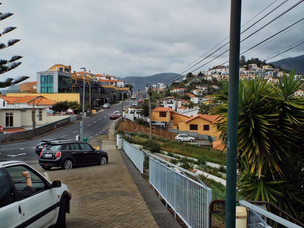 Zaparkowane auta na stromej ulicy w Funchal