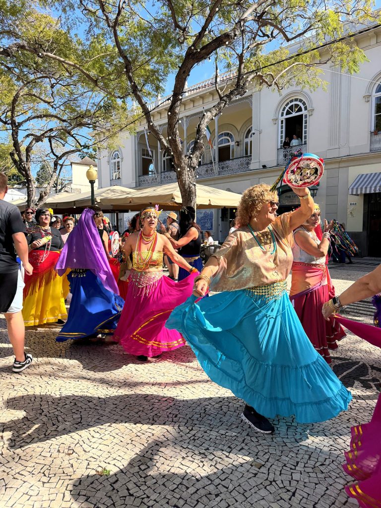 Tancerki w kolorowych spódnicach podczas Carnaval Solidário na Avenida Arriaga w Funchal